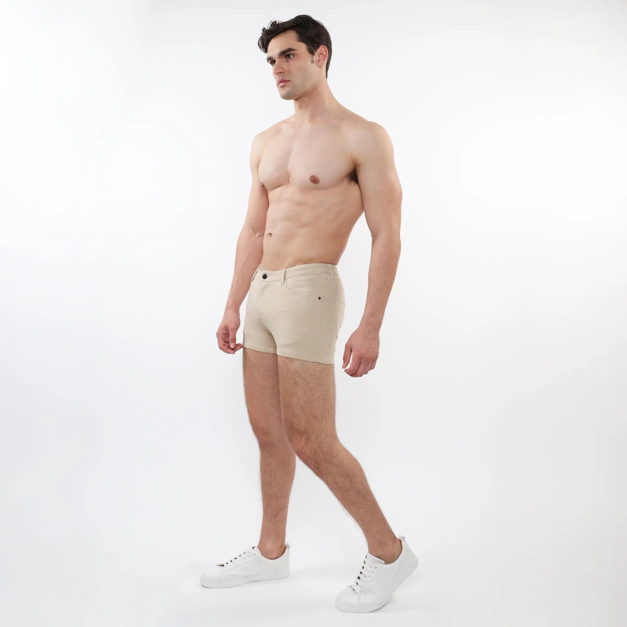 Beige 3 inch stretch knit short briefs with a classic five pocket design and button closure