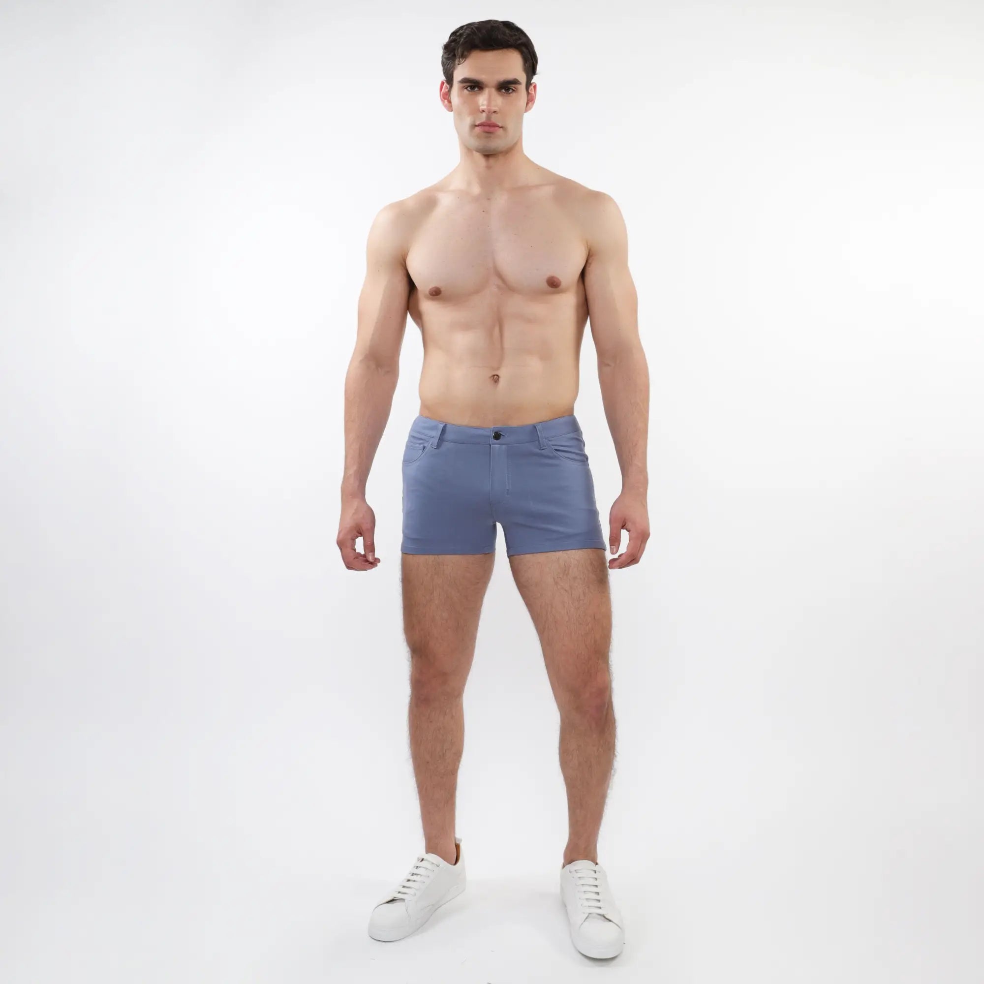 A pair of men’s light blue slim-fit 3 inch stretch knit shorts with classic five-pocket design and button closure