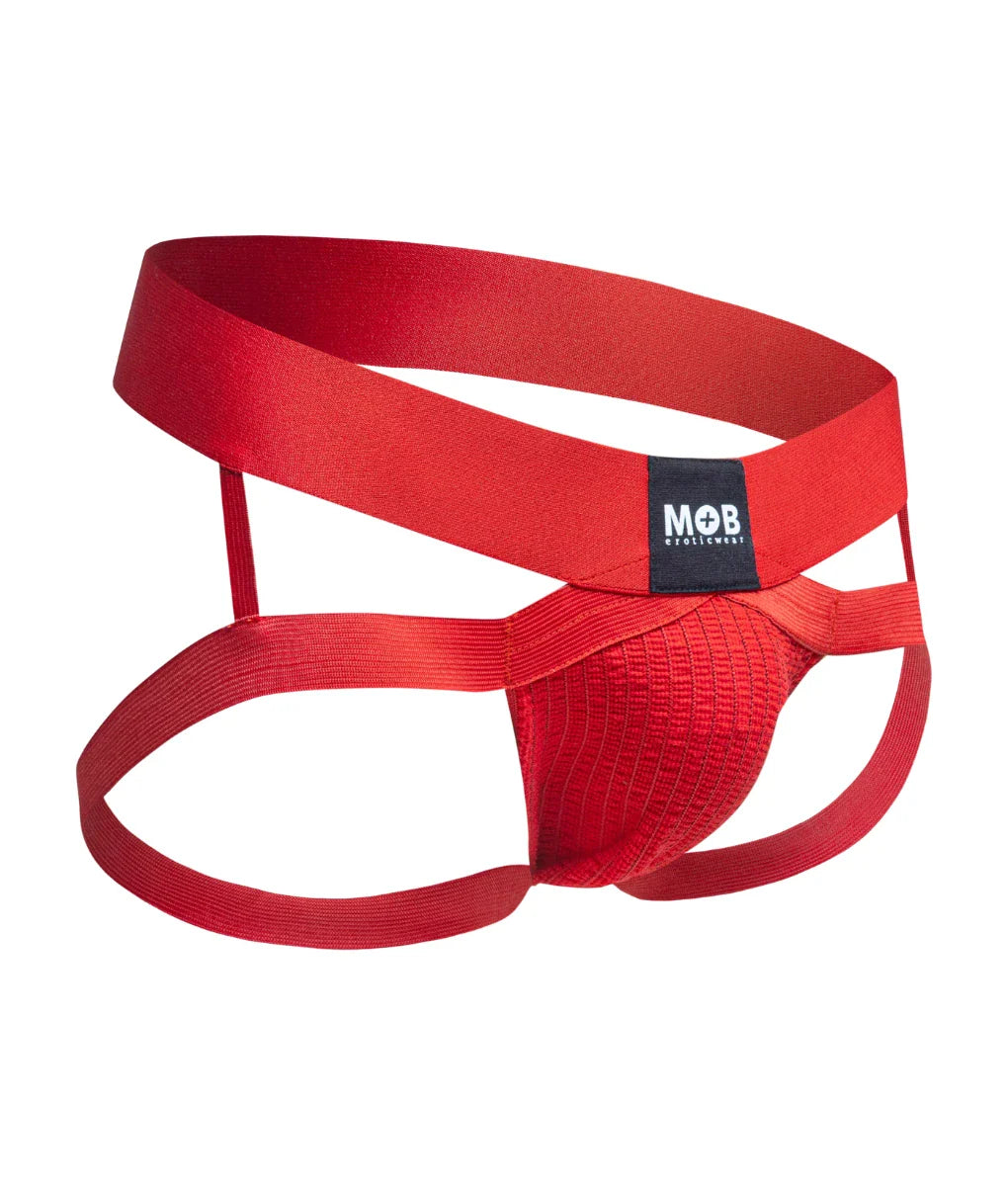 Men’s x jockstrap made of red satin-like fabric with a black mob brand label on the waistband