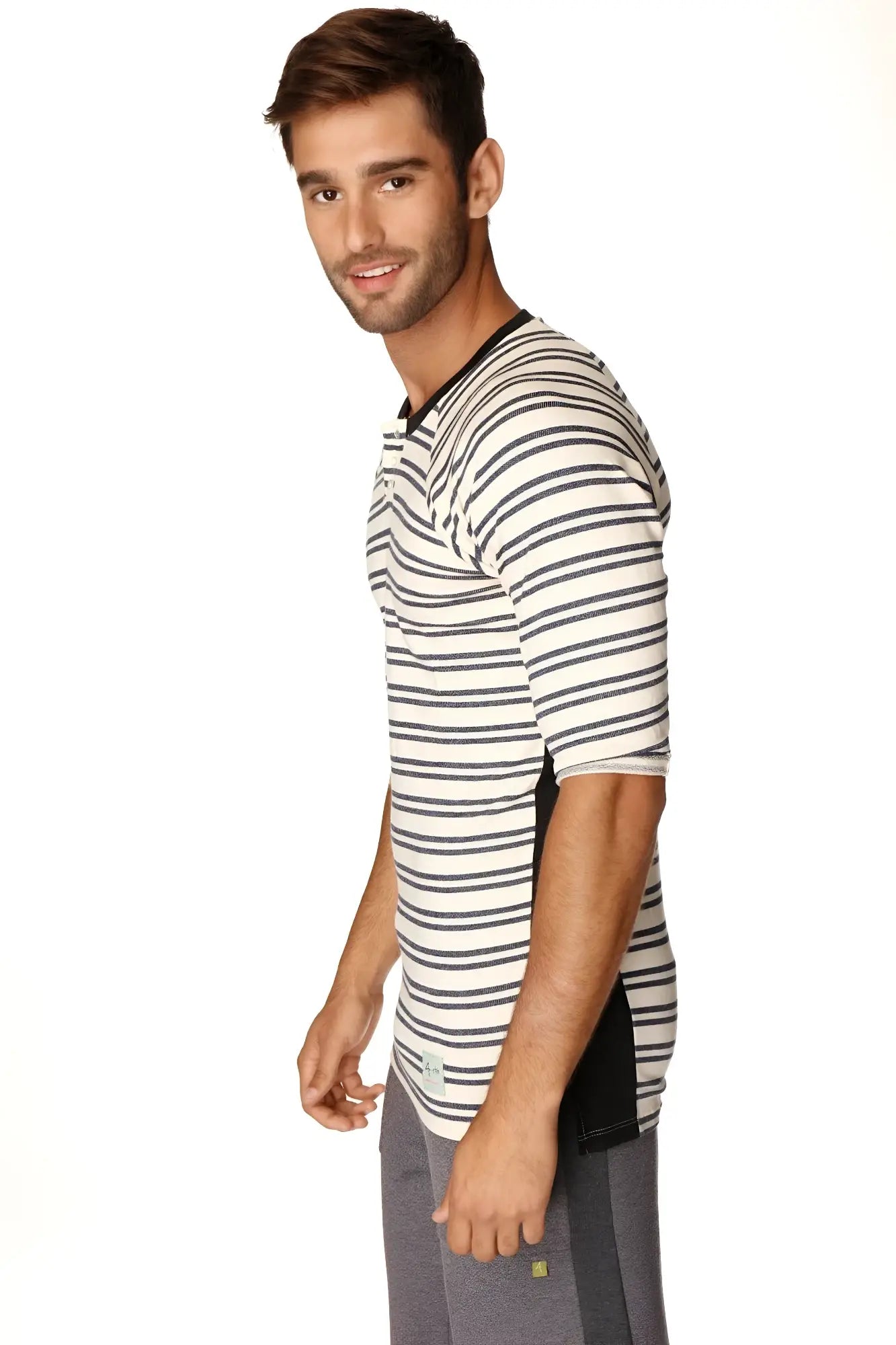 A man wearing a 4-rth mens vintage-stripe henley tee in navy double stripe french terry loop with black and white stripes