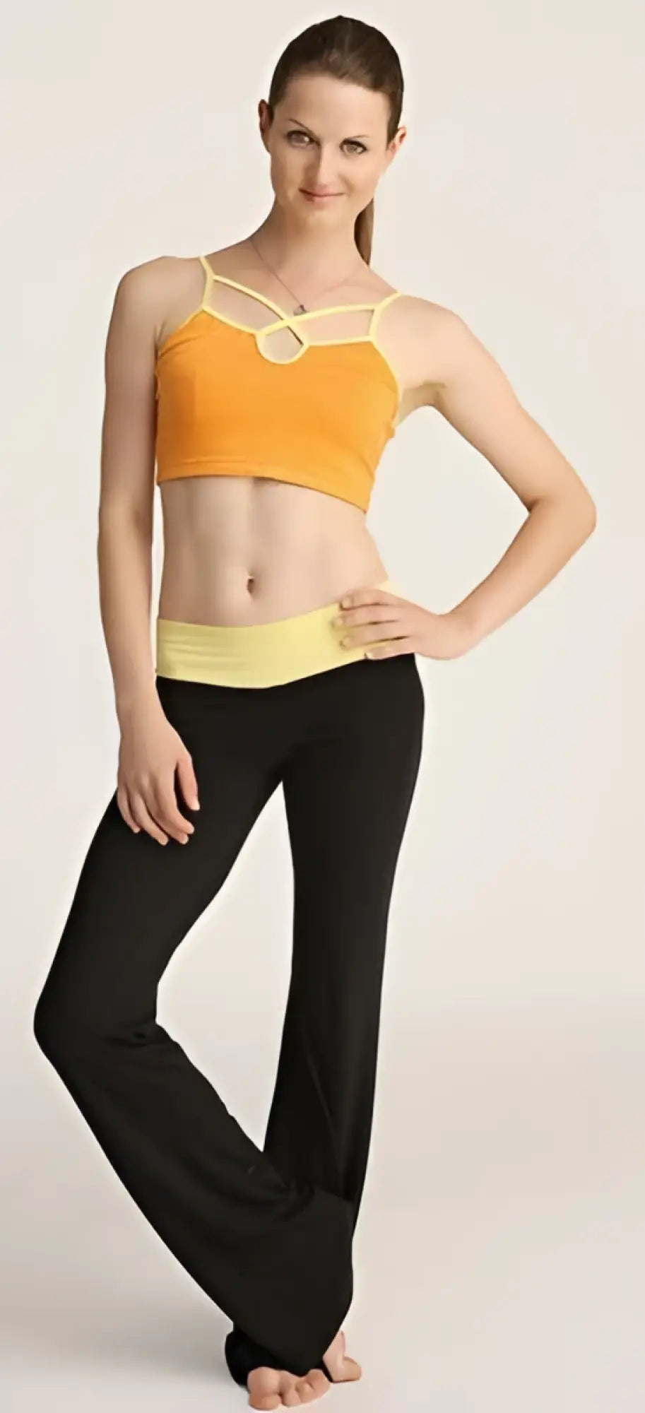 Orange and yellow sports bra with thin straps and front circular cutout paired with 4-rth women’s classic yoga pant