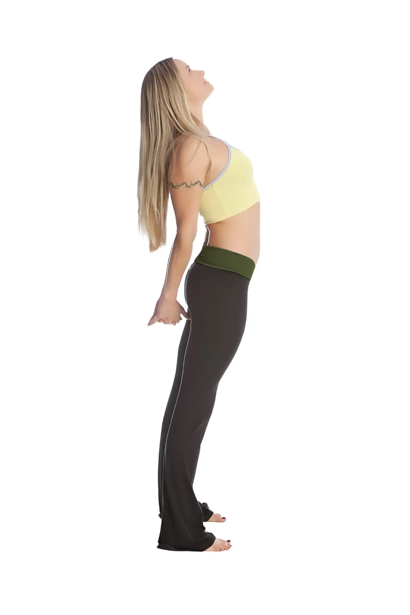 A woman wearing 4-rth women’s classic yoga pant with olive green waistband and black fabric paired with a yellow sports bra