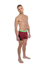 Performance yoga leggings short in brick red heather with maroon and black athletic briefs and bright green waistband
