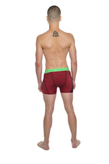 Red athletic briefs with bright green waistband designed for performance yoga and active wear comfort