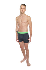 Dark gray boxer briefs with bright neon green elastic waistband and brand logo shown with performance yoga leggings charcoal heather