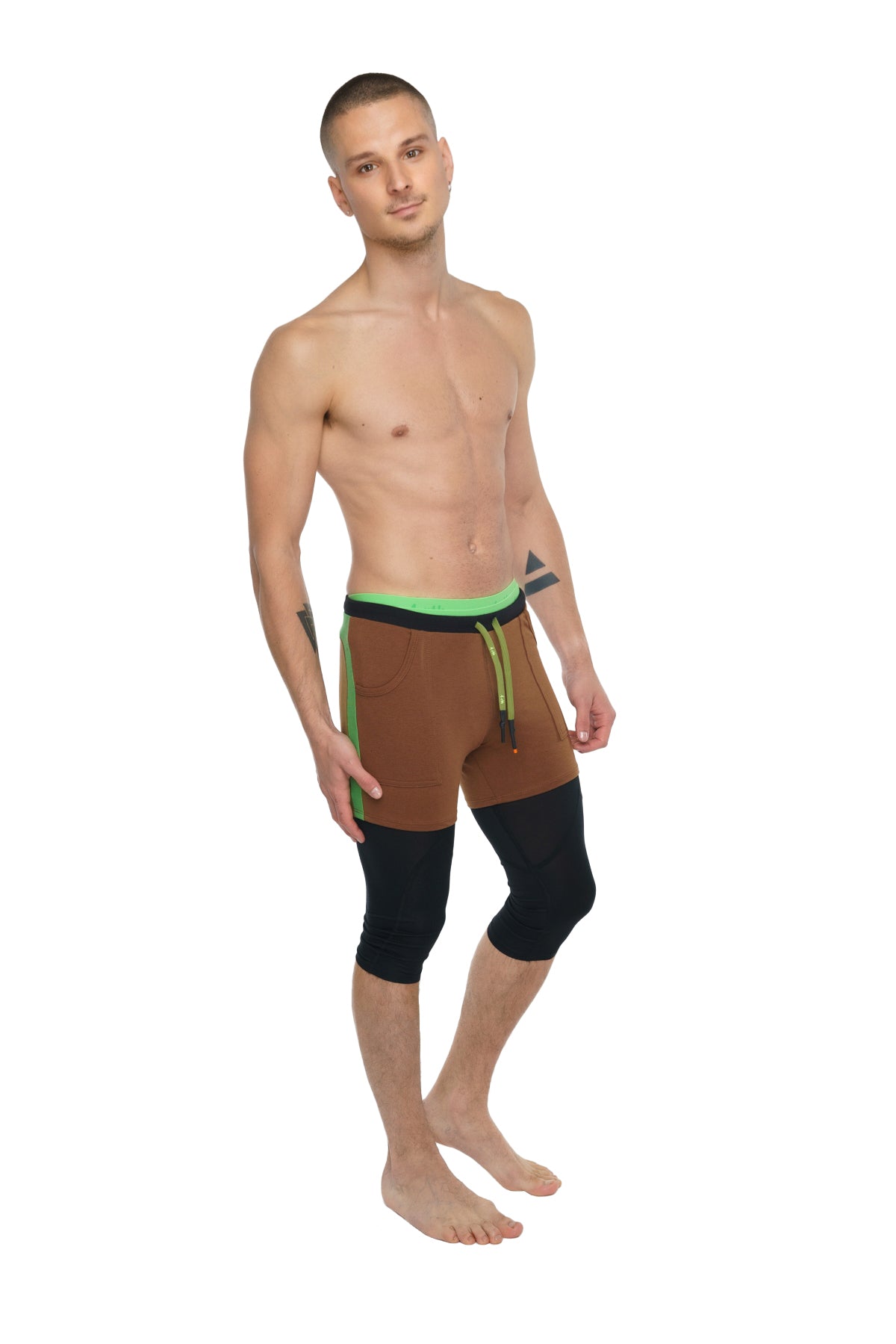 Performance yoga leggings 3/4 in carbon black with brown and black athletic shorts featuring neon green waistband and drawstring