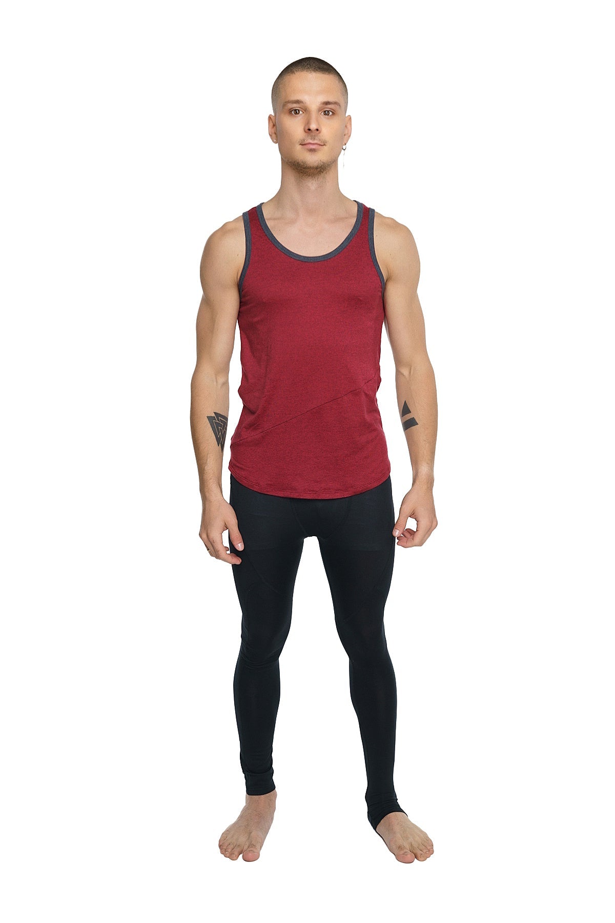 A man wearing the perfect tank brick red with dark gray trim and black leggings showing the front view