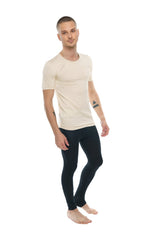 A man wearing a sand beige perfect pocket crew-neck tee made of soft fabric with short sleeves and black leggings