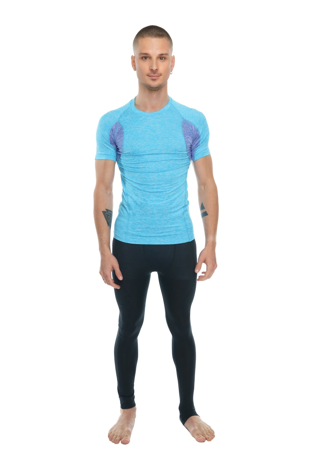 Light blue short-sleeved athletic shirt with purple wing patterns paired with carbon black performance yoga leggings long