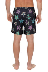 Black 4 way stretch swim shorts with vibrant neon pink teal and yellow starfish pattern on black fabric