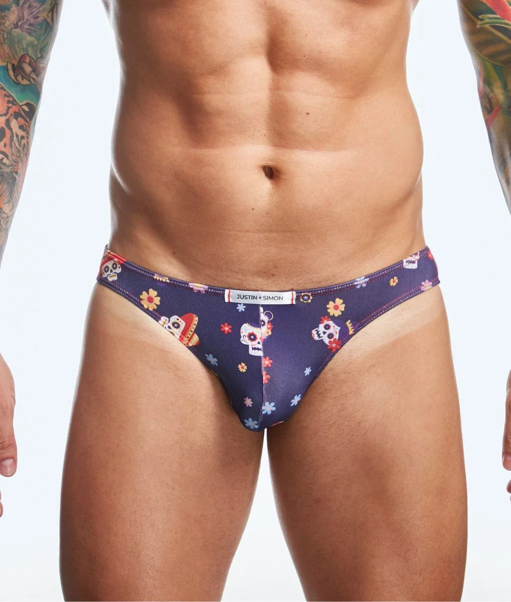 Dark blue mens briefs with vibrant sugar skull and floral print featuring justin simon waistband branding