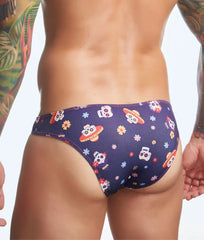 Dark blue men’s swim trunks by Justin + Simon featuring a playful cartoon skull and sombrero pattern with flying saucers
