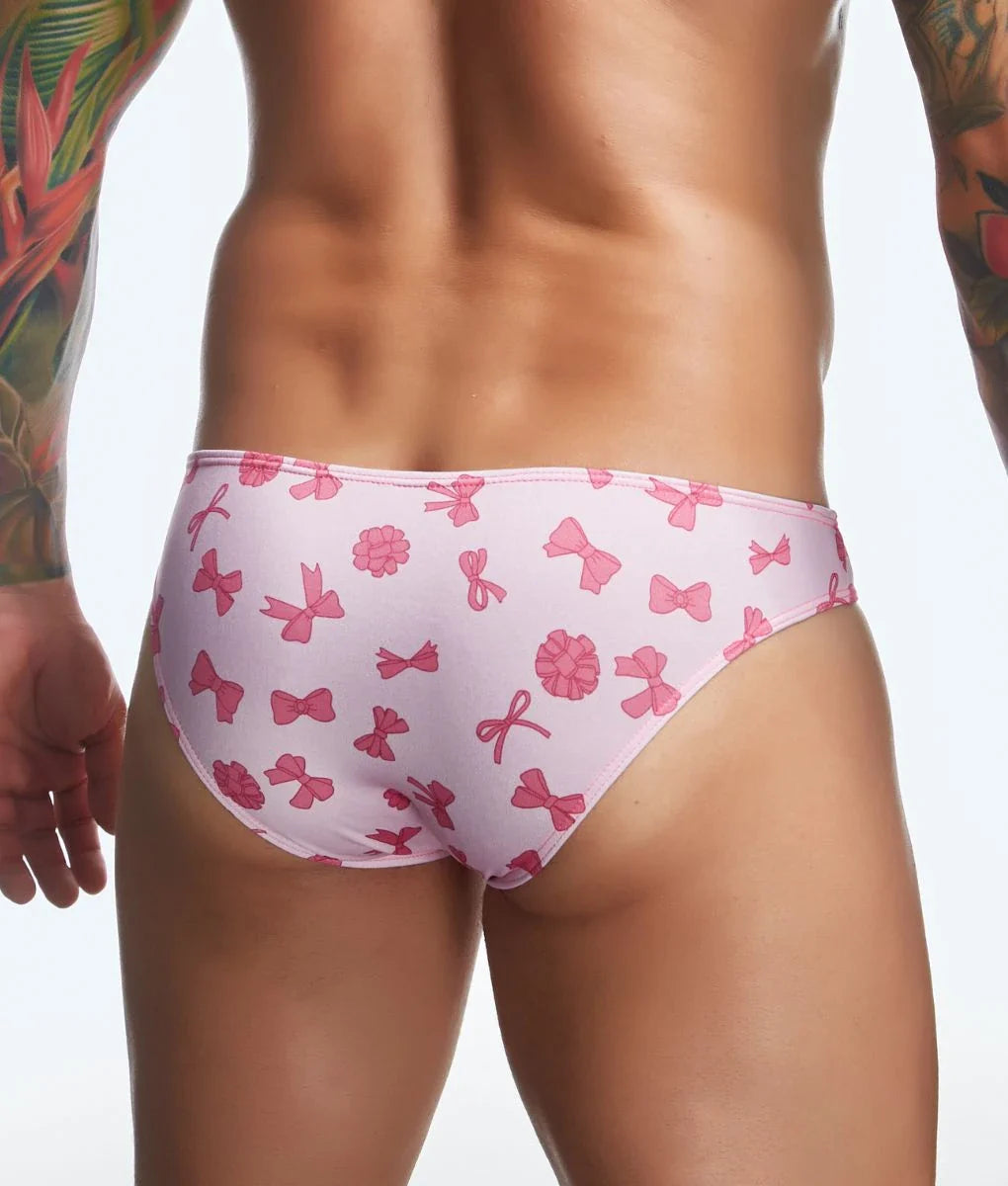 Justin plus Simon classic mens bikini swim trunks with pink bow and flower print for fun beachwear use