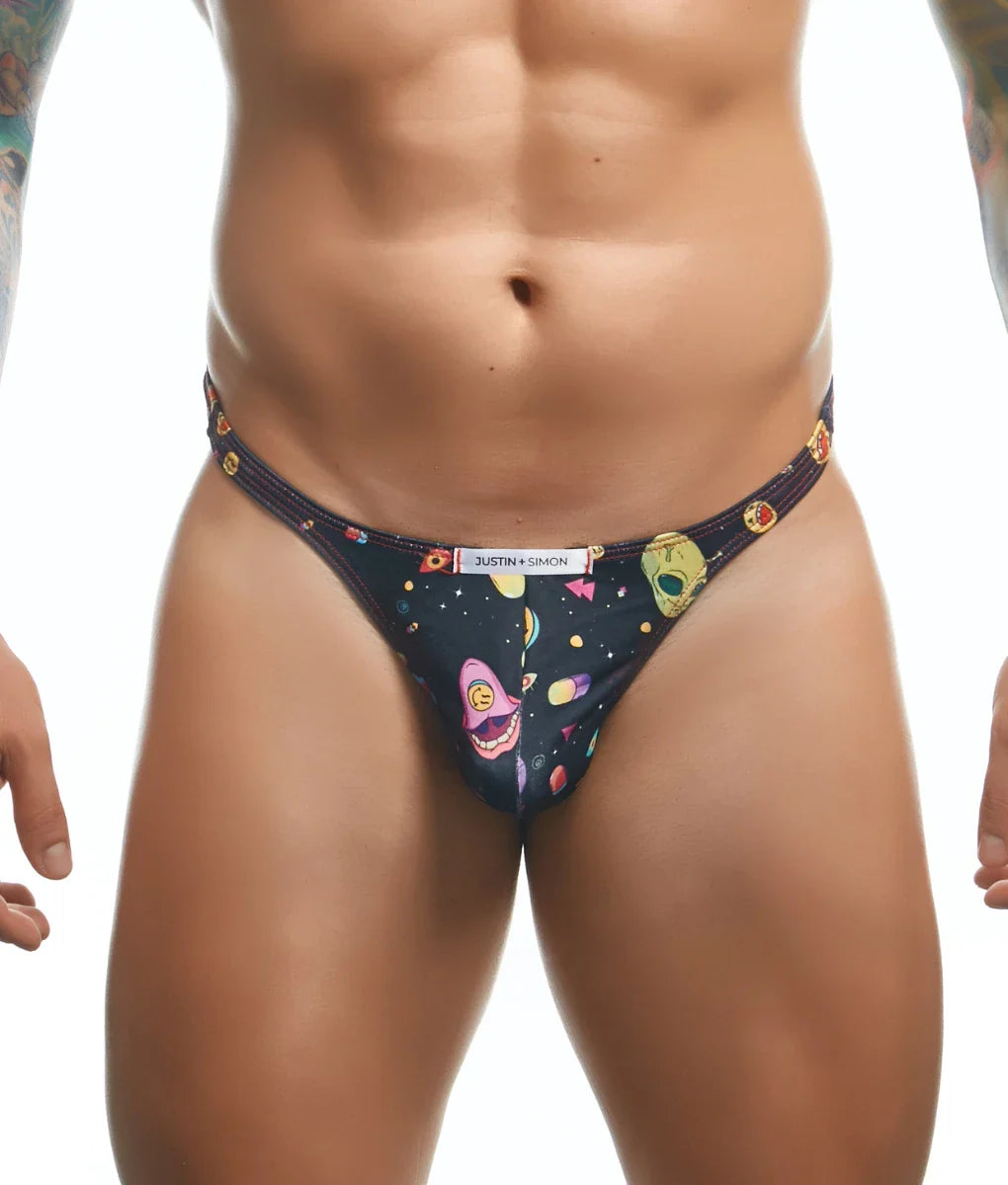 Black thong featuring vibrant cosmic design with colorful alien faces planets and geometric shapes by Justin + Simon Classic Tanga Fun Prints