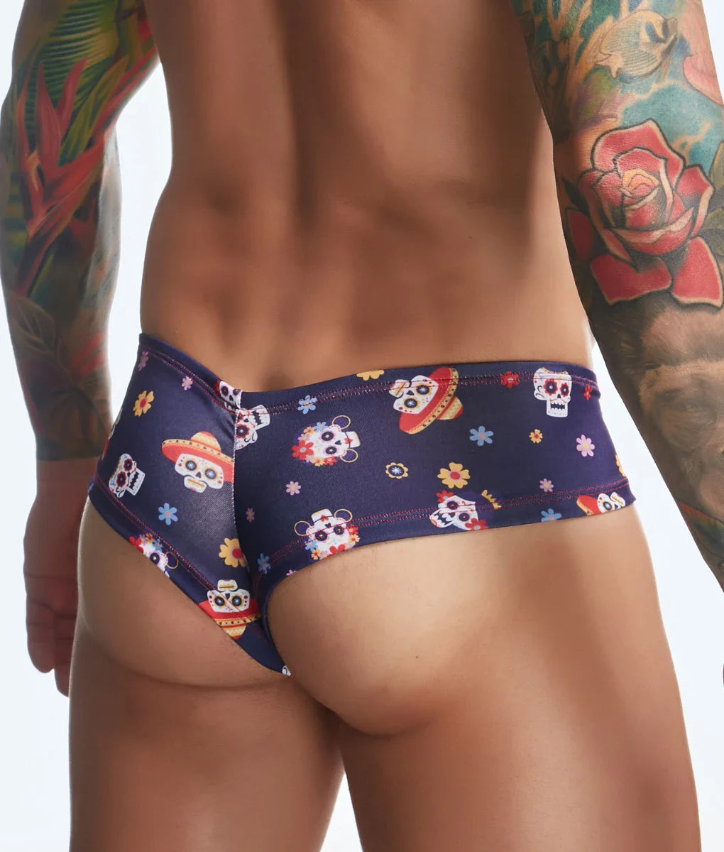 Dark blue swim trunks with vibrant sugar skull and floral pattern from justin + simon cheek fun prints collection