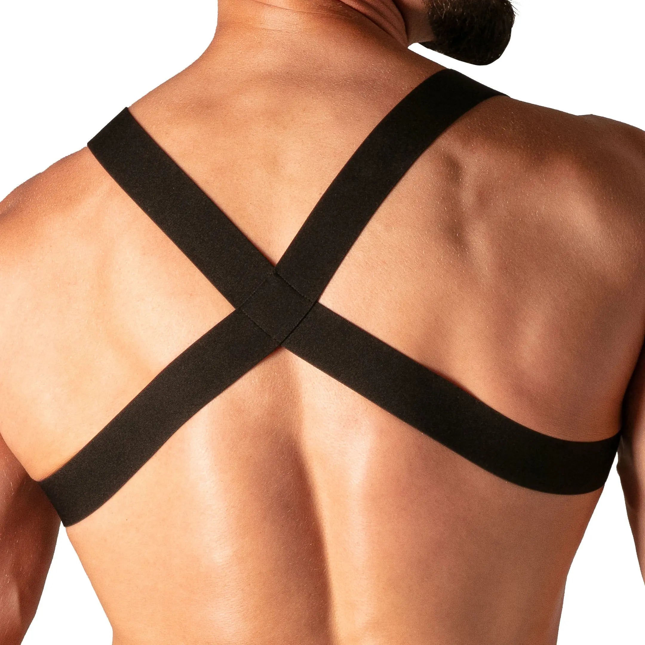 Close-up of a man's back wearing a black elastic harness with crossed straps by Absolu Male By TOF Paris