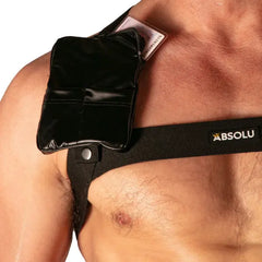 Black pocket harness with snap closure and card slot worn on shoulder and chest by a shirtless man branded Absolu Male By TOF Paris