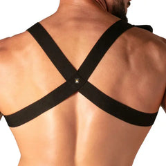 Back view of a man wearing a black elastic cross-back harness with a small metal logo detail by Absolu Male By TOF Paris