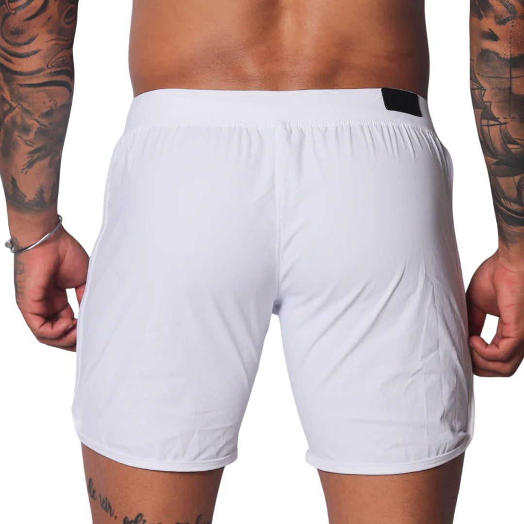 Plain white athletic shorts with a smooth, lightweight fabric, elastic waistband, and small black logo tab on the back.