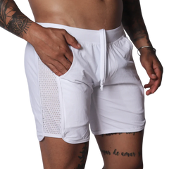 White athletic shorts with a drawstring waistband and side panels made of breathable mesh fabric.