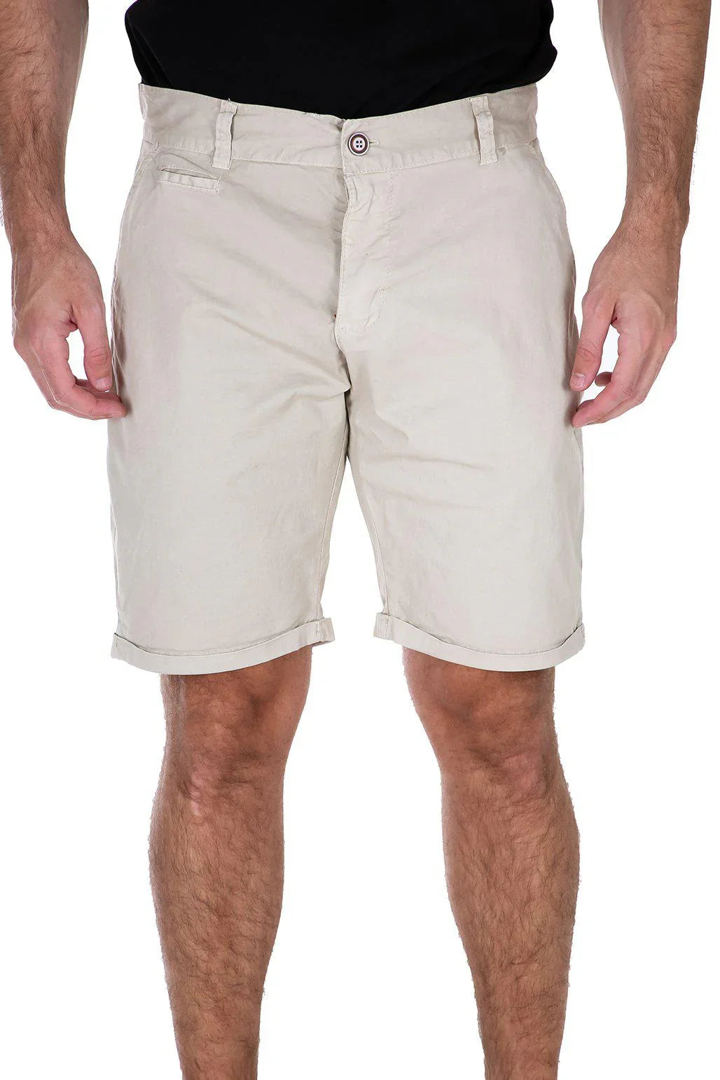 A man wears Bespoke Essential Cotton Shorts in beige, featuring cuffed hems and a button closure.