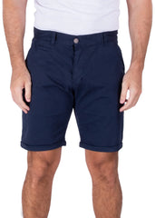 A man wearing dark navy blue Bespoke Essential Cotton Shorts with cuffed hems and a white t-shirt.
