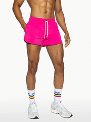 Bright pink bike track short with white drawstrings designed for athletic use and comfortable fit