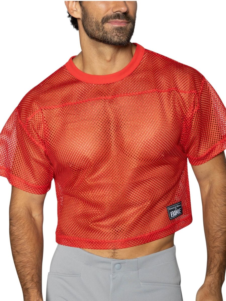 Red mesh crop top with solid red ribbed neckline and hem featuring black bike patch on lower left side
