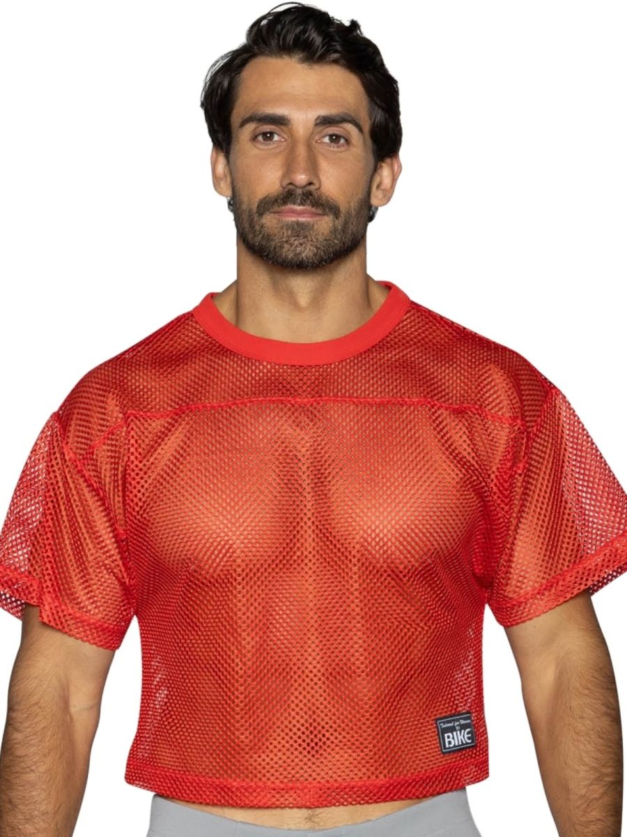 Red mesh crop top with solid red ribbed neckline hem and small black bike brand patch bright red color