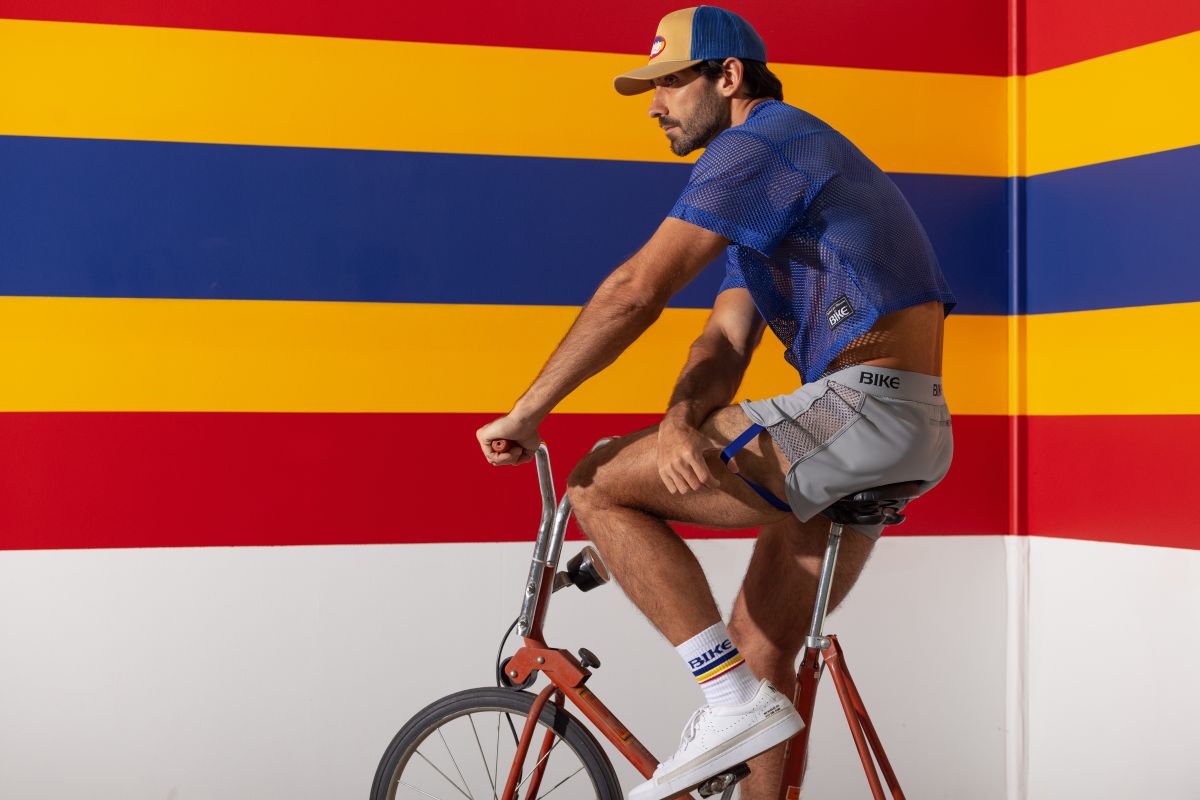 Man wearing royal blue mesh bike athletic BAM134 short sleeve practice jersey and gray bike shorts with bike branding