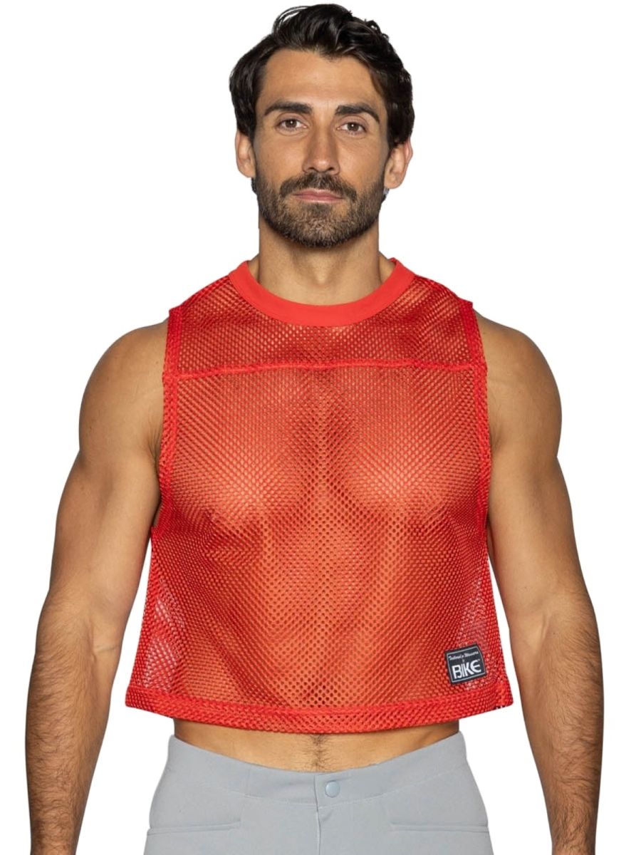 Red mesh crop top with ribbed neckline and hem featuring small black bike brand patch on lower right side
