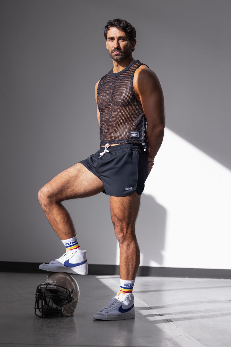 Black mesh sleeveless top with small white logo on lower right side paired with bike athletic bam200 black track shorts