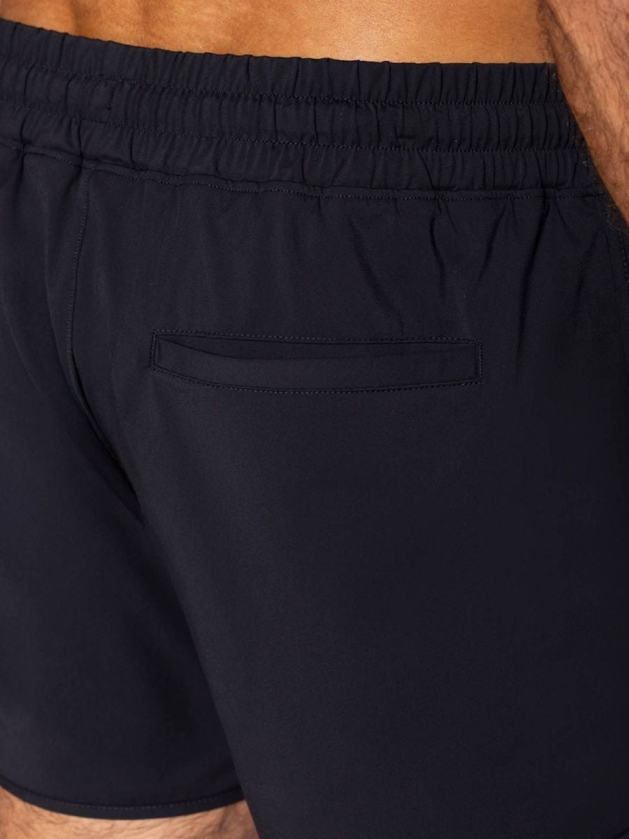 Black bike athletic bam200 track shorts shown from the back with elastic waistband and single back pocket