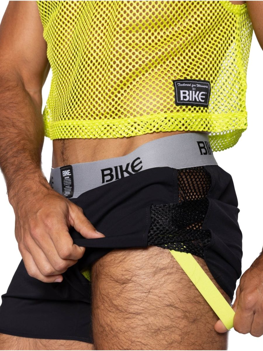 Bright neon yellow mesh crop top with black fabric accents and bike branded waistband for athletic use