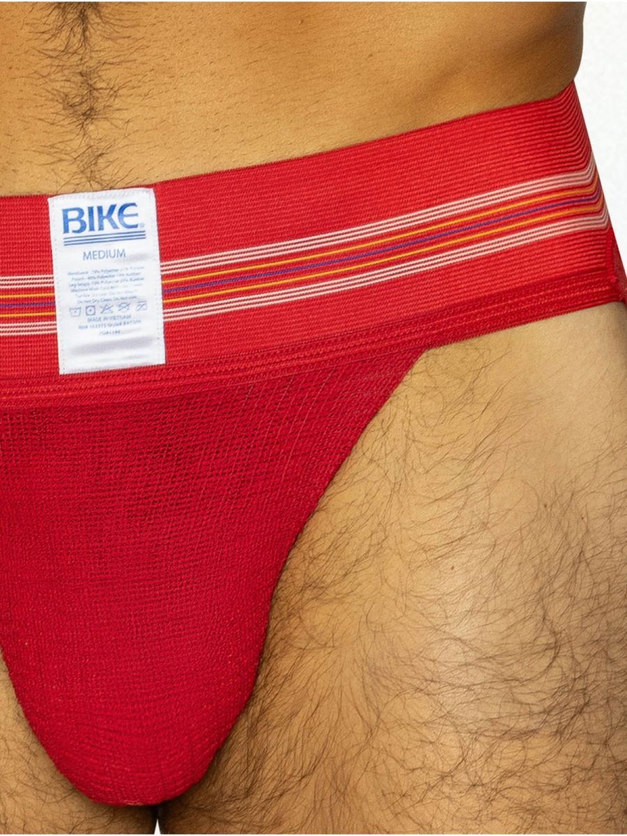 Red bikc brand jockstrap with striped elastic waistband designed for athletic support in vibrant red color