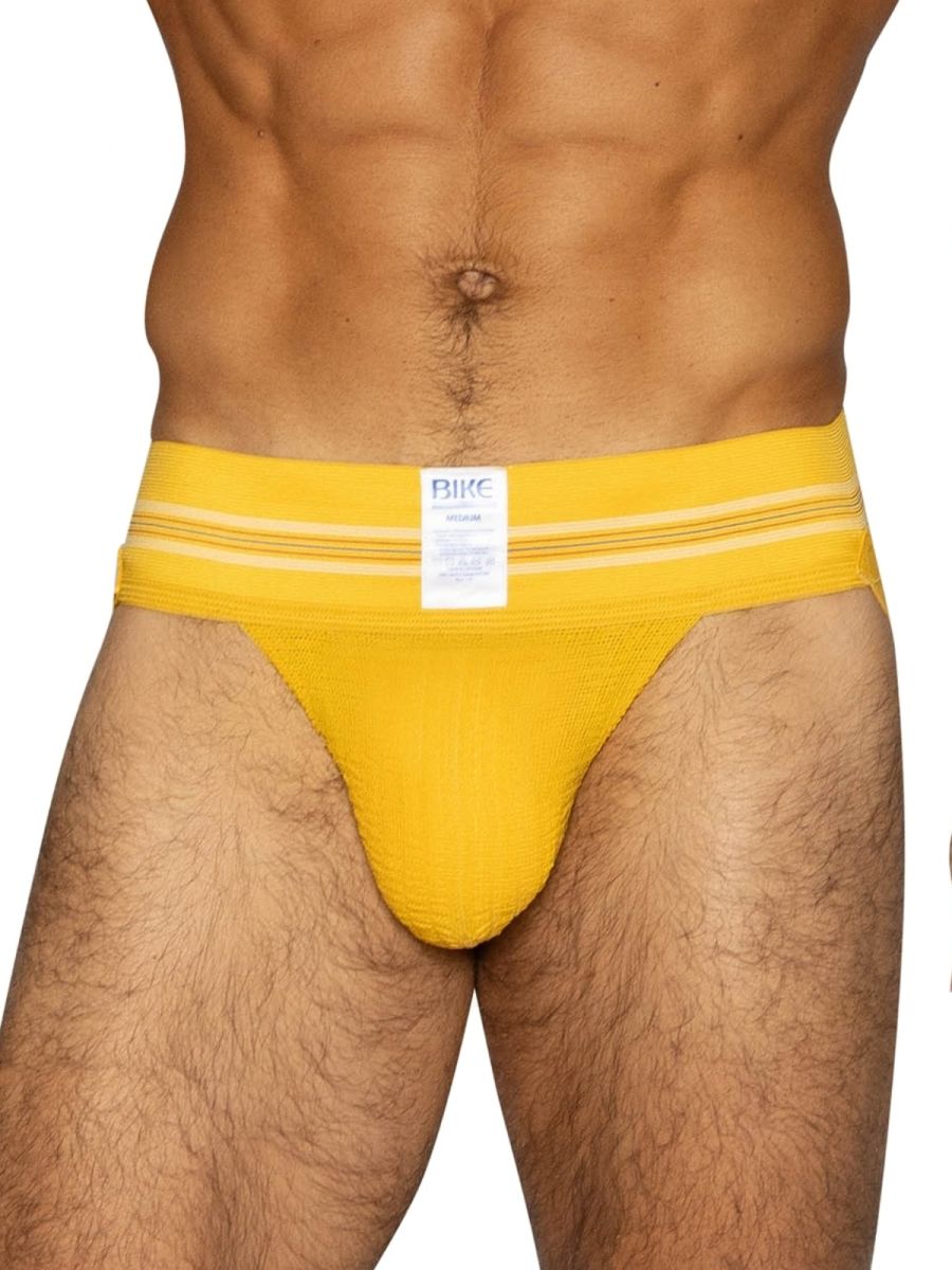Bright yellow bike athletic briefs with white stripes and a branded label designed for sports use