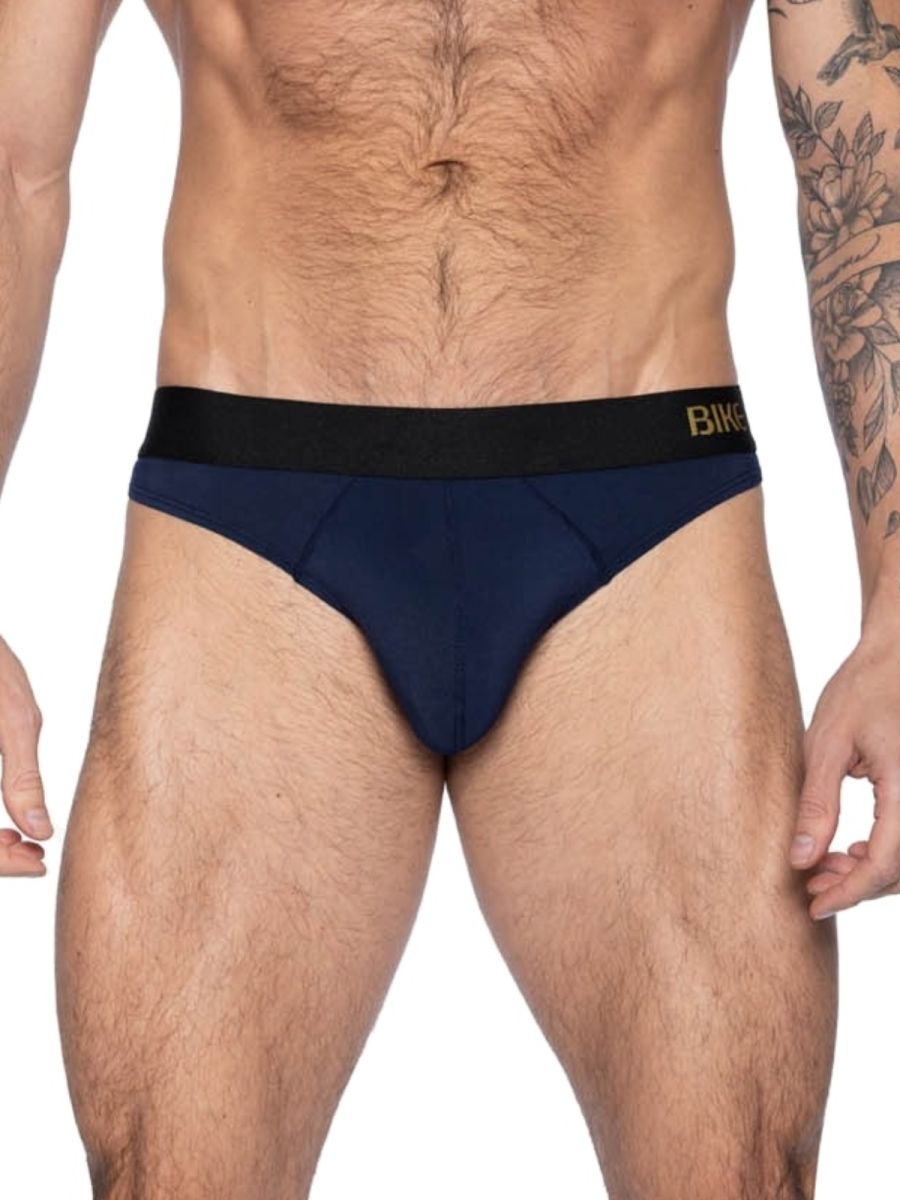 Navy blue bikini briefs with black elastic waistband featuring gold brand name designed for athletic active use