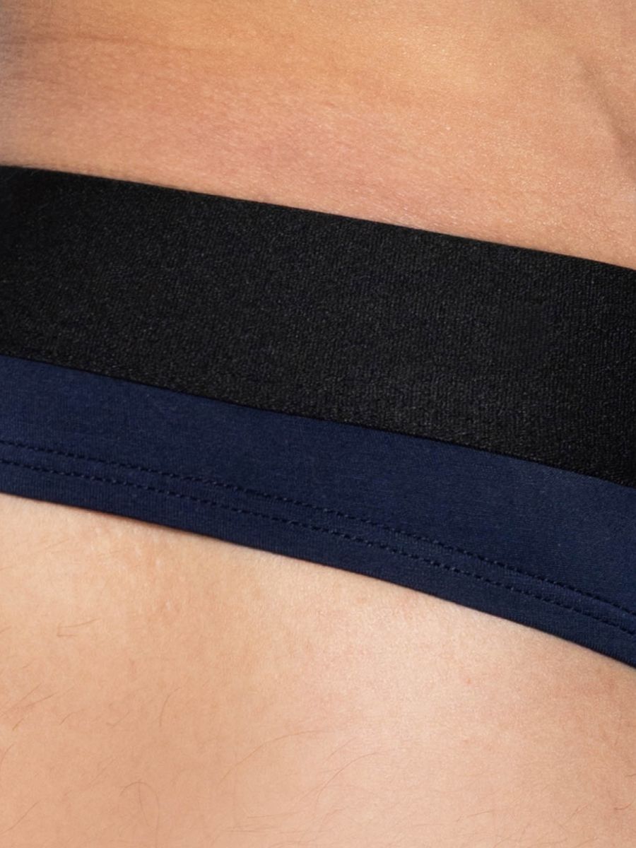 Navy blue bike athletic active thong with black elastic waistband and visible stitching in back view