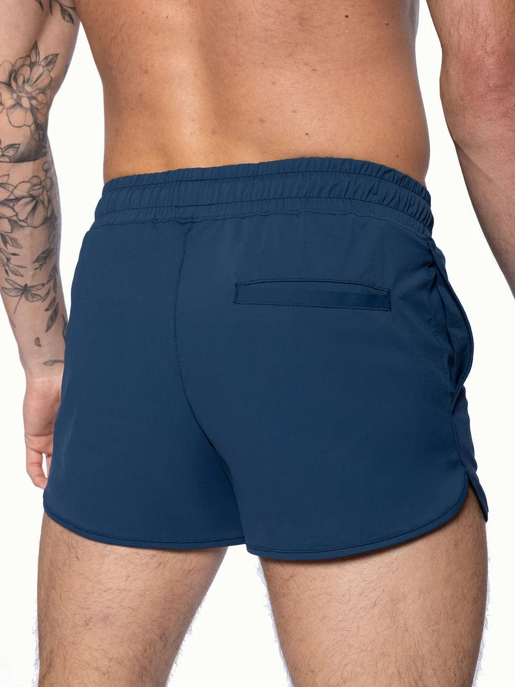 Back view of navy blue BIKE track shorts with elastic waistband and single back pocket for athletic use