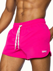 Bright pink bike track short with white drawstrings and small bike logo on the side for athletic use