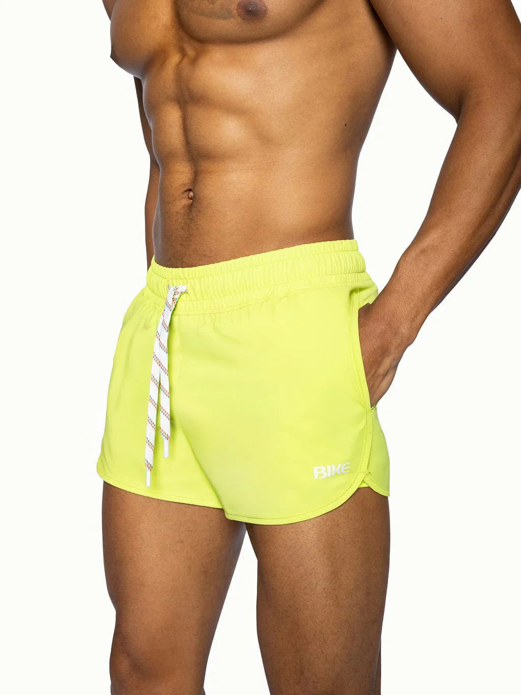 Bright neon yellow bike track short with white striped drawstring and subtle brand logo on lower right leg
