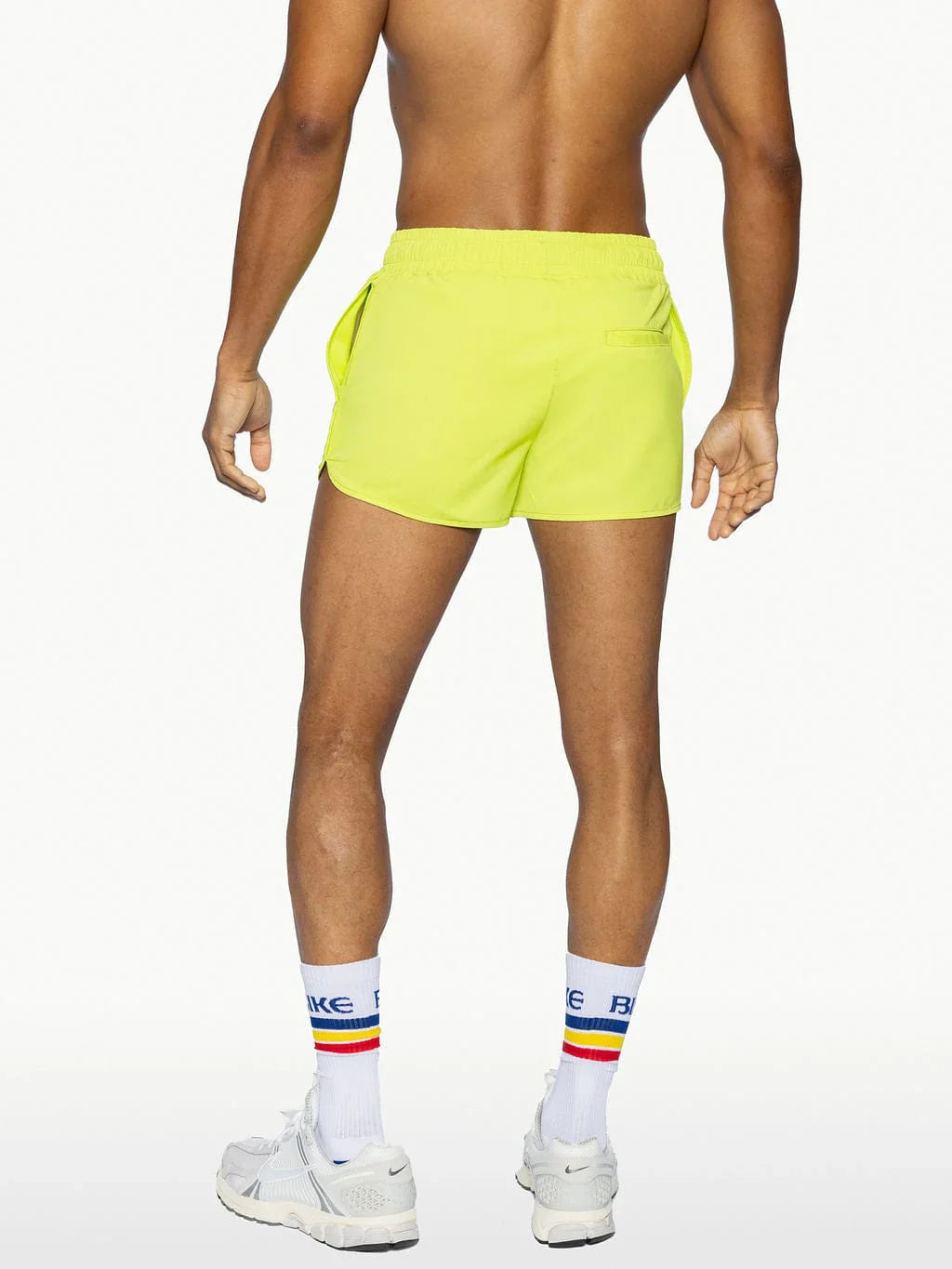 Bright neon yellow BIKE® TRACK SHORT athletic shorts with sleek modern design and side pockets for active use