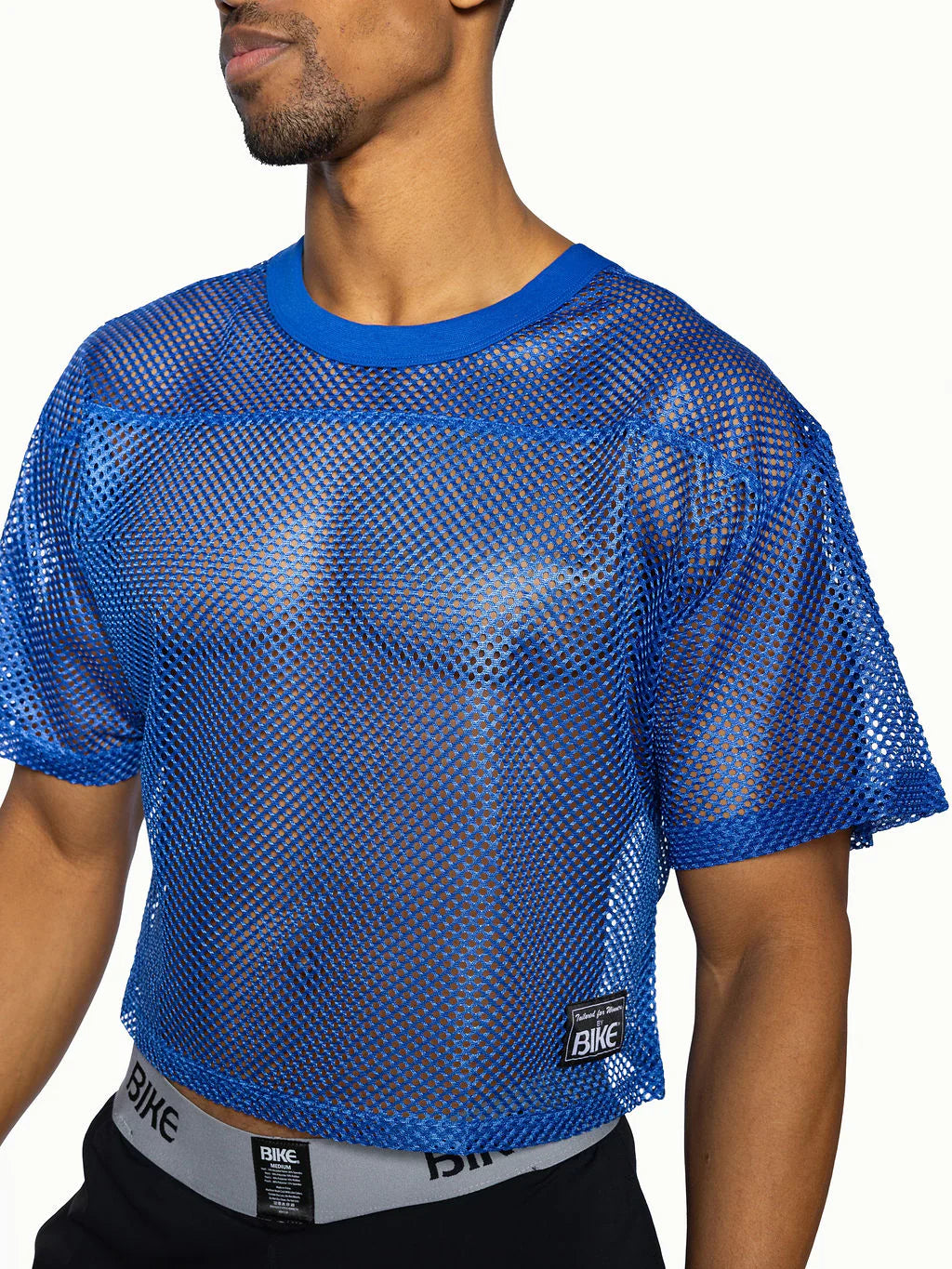 Bike practice jersey blue mesh crop top with solid blue ribbed neckline and sleeve cuffs for active wear