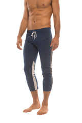 Mens navy blue athletic capri yoga pants with white side stripes and matching drawstring waistband