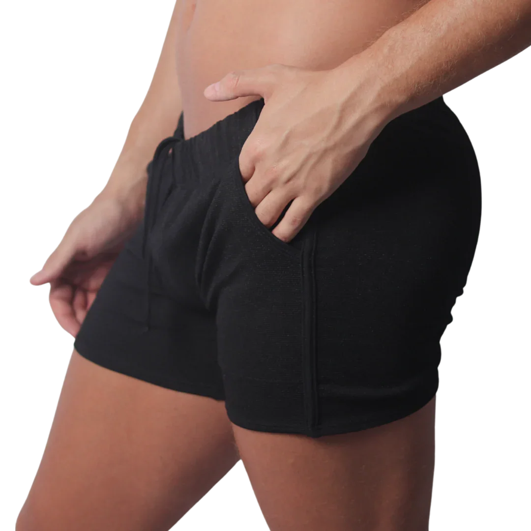 Black knit athletic shorts with an elastic drawstring waistband and side pocket detailing.