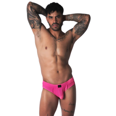 Fuchsia jockstrap brief with a smooth, matte finish and a central black logo detail on the waistband.