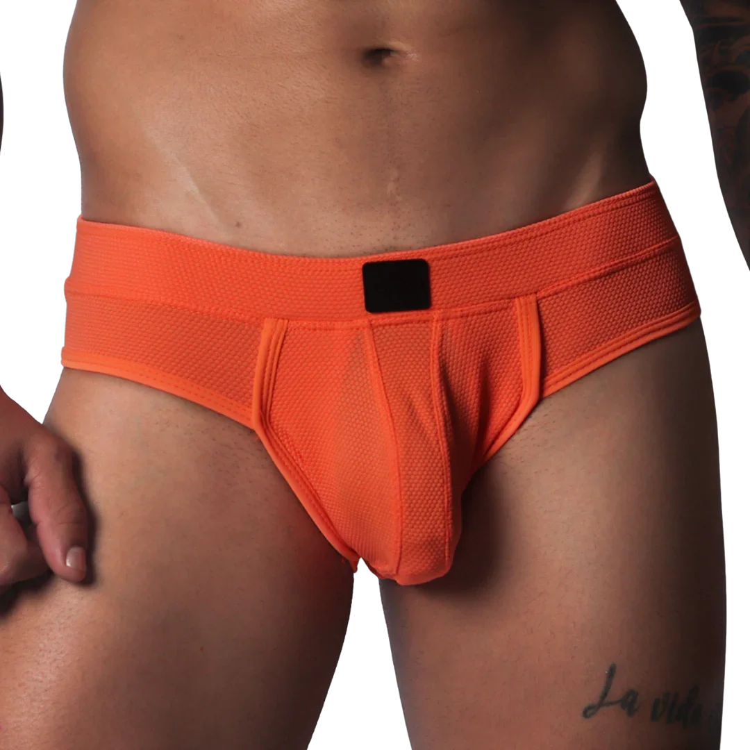 Bright orange athletic jockstrap made of textured honeycomb fabric with a solid black center label on the waistband.