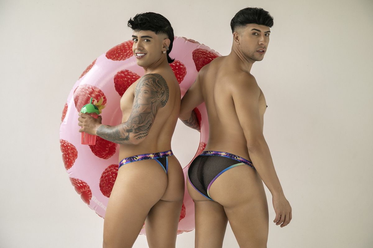 Pink inflatable strawberry pool float alongside candyman 99935 briefs in black showing front view