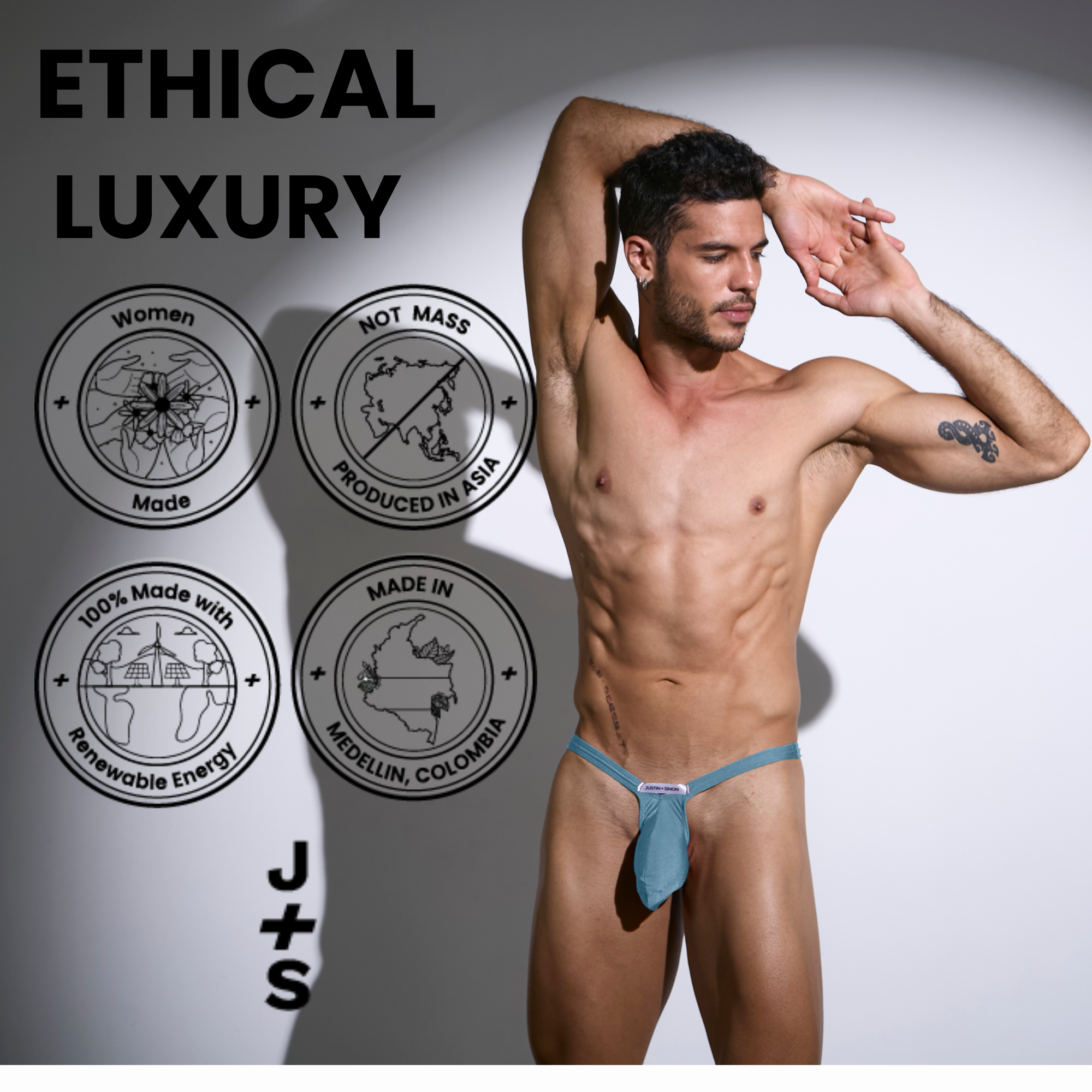 A teal form-fitting men’s bulge thong by Justin Simon with a small brand tag at the front