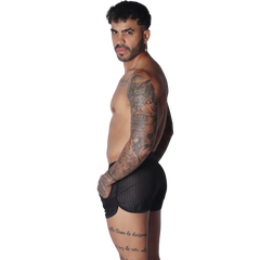Black athletic mesh short with a curved hemline and pocket detail, worn by a shirtless man.